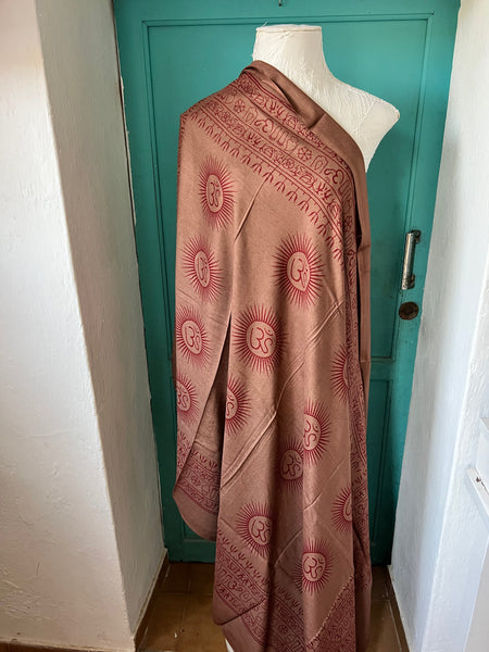 Woman wearing the Aurobelle Om mantra sarong in dusty rose, Es Vedrà in the background