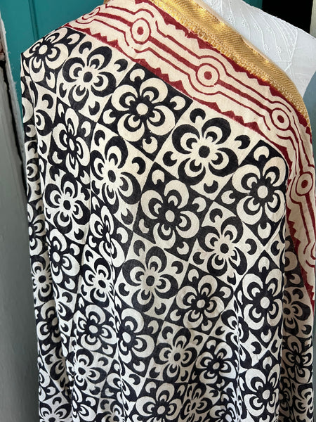 Aurobelle Ibiza Es Vedrà sarong worn as a beach cover-up in a Mediterranean coastal setting