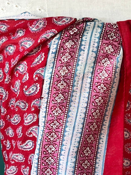 Sal sarong tied at the waist over a swimsuit