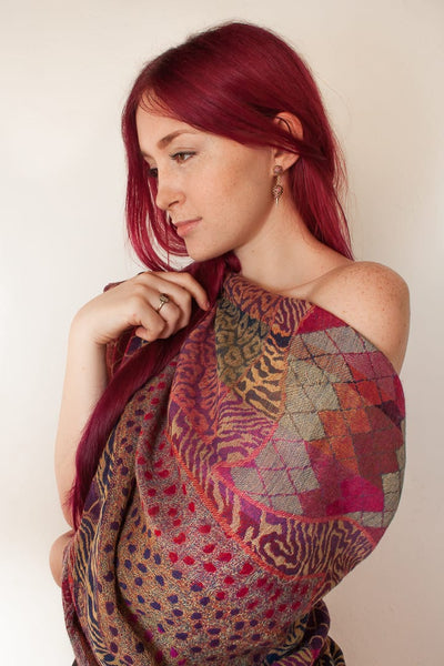 Cosy merino wool shawl in warm red and brown abstract design